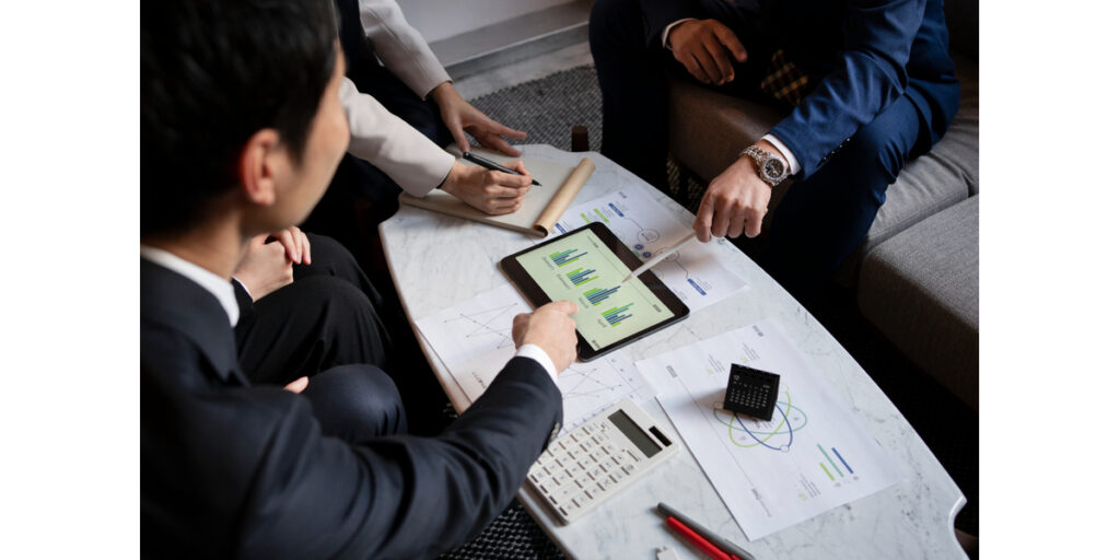 Business meeting with data analysis tools.